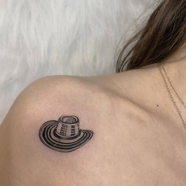 a woman with a tattoo on her shoulder has a doctor who is in the hat