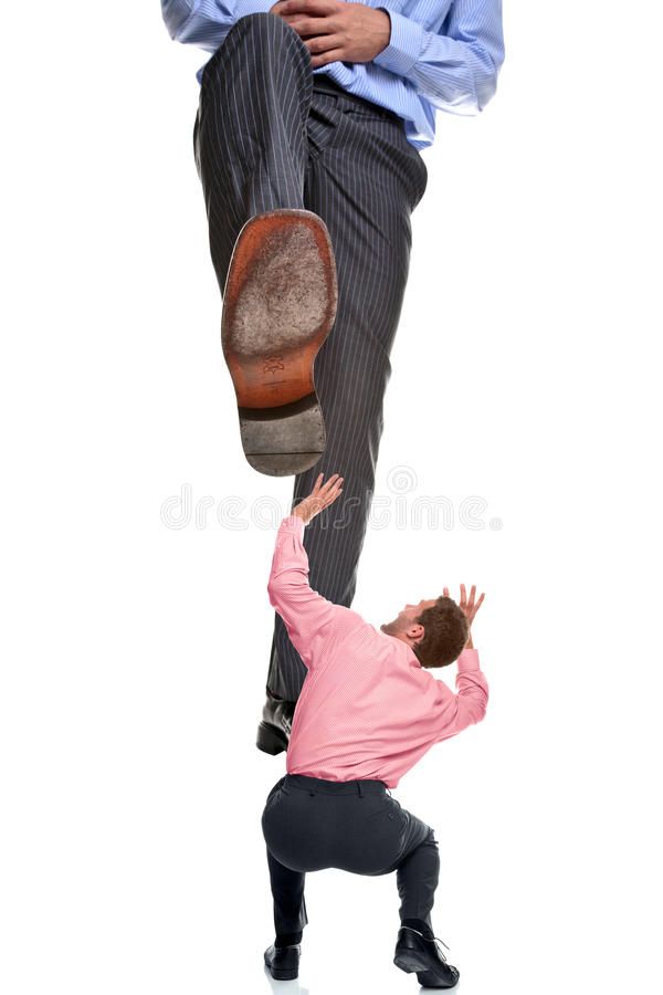 a man in pink shirt and black pants standing on one leg with his foot up