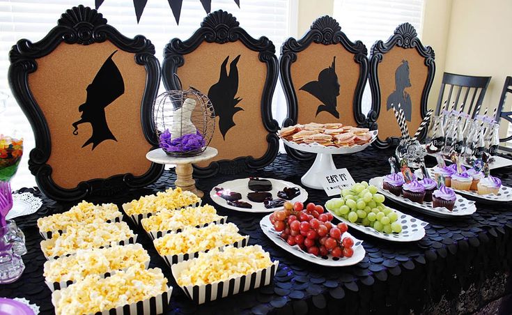 a table topped with lots of desserts and snacks