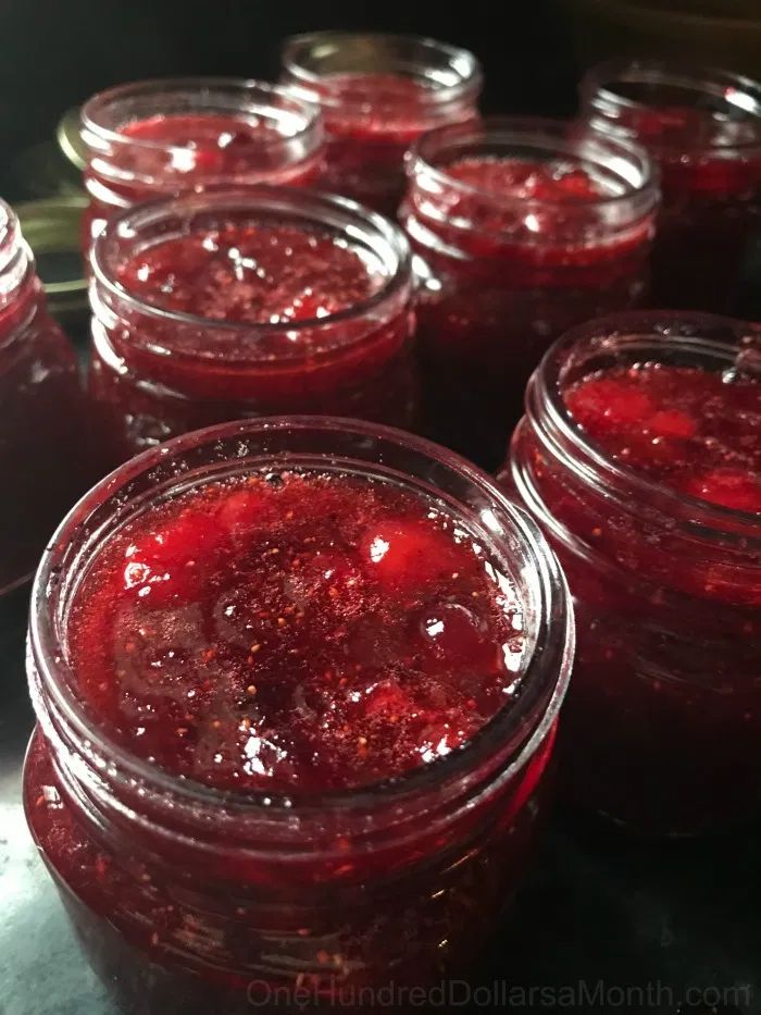 jars filled with jam sitting on top of a table