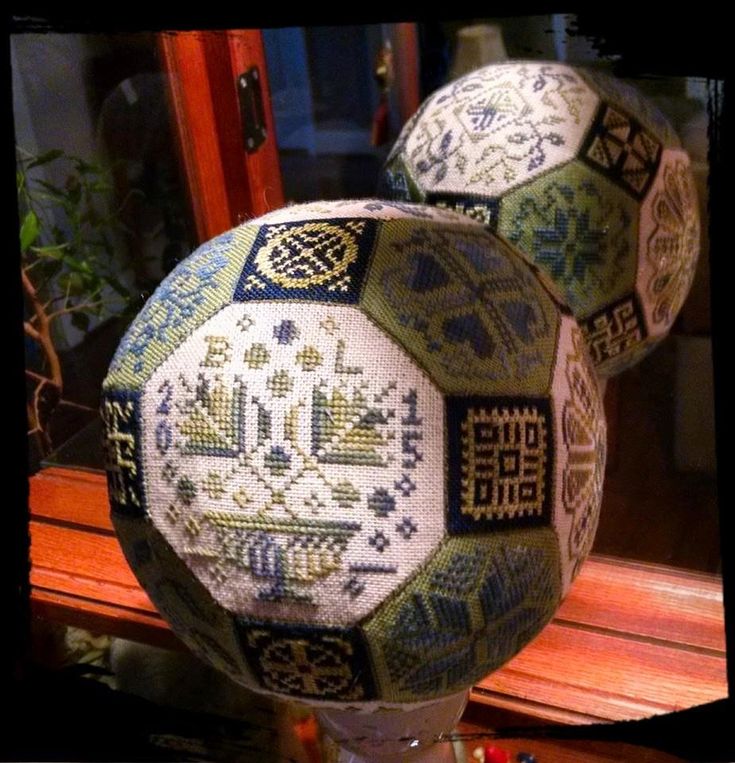 two decorative balls sitting on top of a wooden table