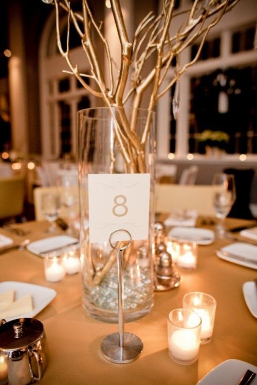 the table is set with candles and place cards