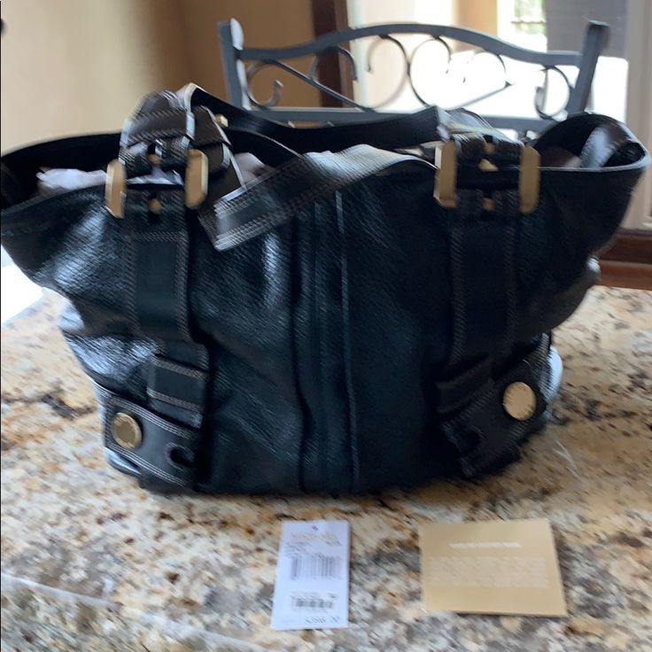 Michael Kors Harness Grab Bag In Beautiful Black Pebbled Leather, Gold Tone Hardware. Interior Zip Pocket And Four Pockets On Inside Front And Back Wall. This Bag Was Stored, Never Used. Looks And Smells Brand New. Interior Zip Pocket, Four Wall Pockets, Key Keeper. Purchased At Bloomingdales. I Have Original Tag. Designer Michael Kors Satchel With Handles, Luxury Michael Kors Satchel With Leather Handles, Designer Michael Kors Leather Satchel, Michael Kors Designer Shoulder Bag With Branded Hardware, Designer Michael Kors Shoulder Bag With Branded Hardware, Michael Kors Designer Shoulder Bag With Silver-tone Hardware, Designer Michael Kors Shoulder Bag With Leather Handles, Michael Kors Luxury Textured Leather Shoulder Bag, Designer Michael Kors Shoulder Bag With Metal Hardware