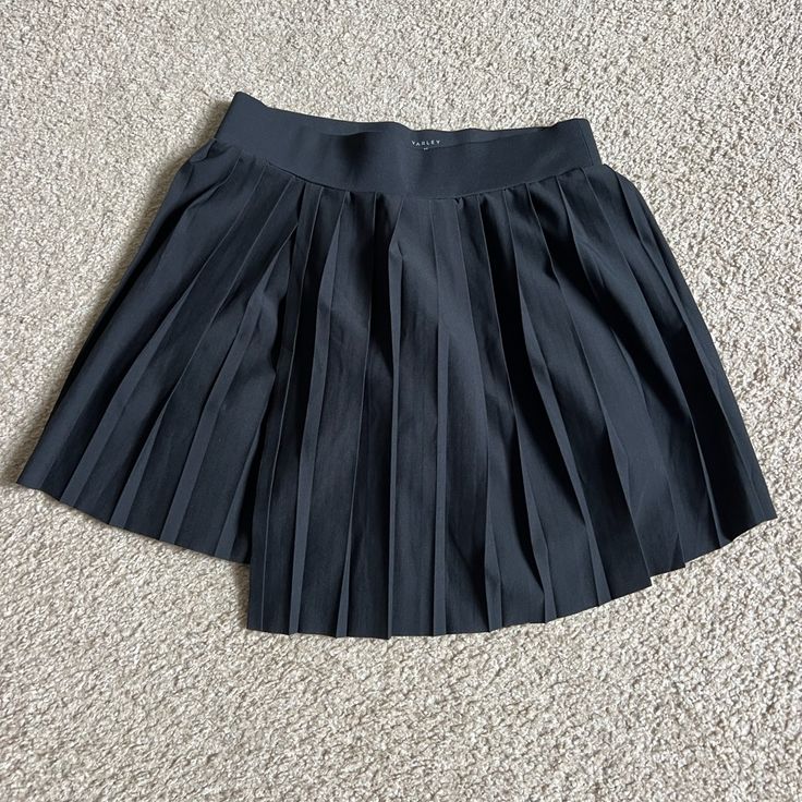 Varley Pleated Mid Rise Skort Color: Black Size: Xs Brand New Without Tags Designed To Take You From Court To Cafe, The Kalmia Mid-Rise Skort Updates A Timeless Tennis Silhouette. This 14.5" Pleated Tennis Skort Is Made From Our Heavy Stetch Woven Fabric For Comfort And Freedom Of Movement. Featuring An Elevated Wrap-Over Front And A Built-In Jersey Short With Side Pockets, It's The Perfect Combination Of Fashion And Function. Casual Pleated Non-stretch Skort, Black Stretch Skort With Pleated Detail, Black Stretch Pleated Shorts, Non-stretch High Waist Pleated Skort, Casual 4-way Stretch Pleated Skort, Black A-line Pleated Skort, Tennis Silhouette, Tennis Skort, Freedom Of Movement