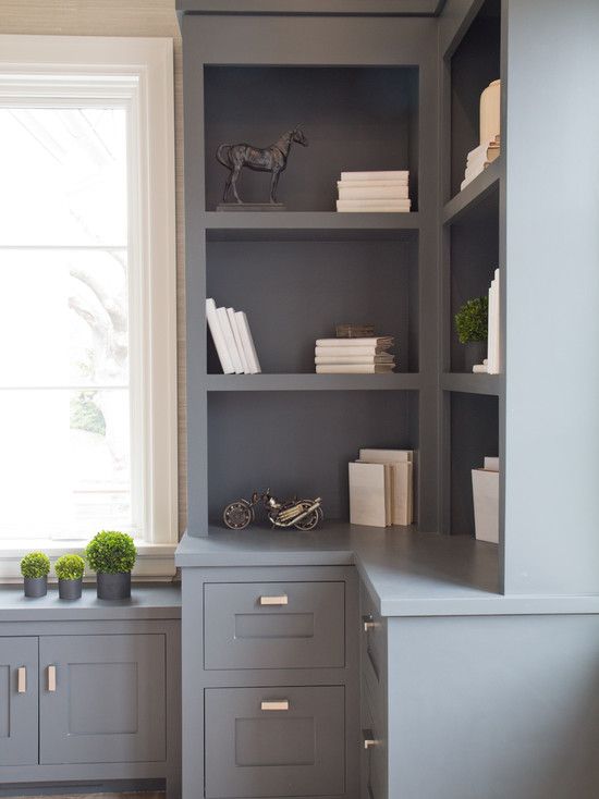 a gray bookcase with some books on it