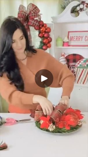 a woman cutting up some christmas decorations on a table