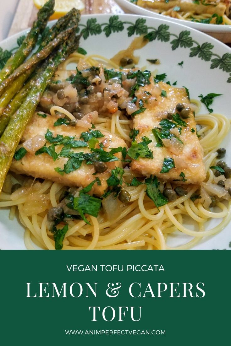 a white plate topped with pasta and asparagus