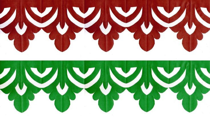 two green and red curtains with white designs on them