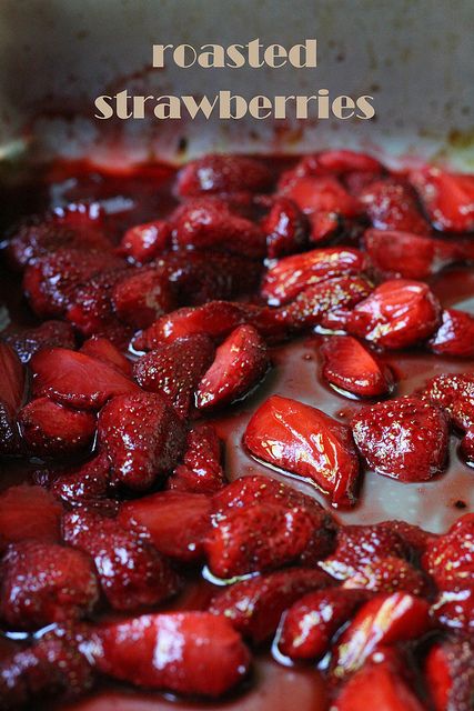 some strawberries are sitting in a pan with sauce on it and the words roasted strawberries above them