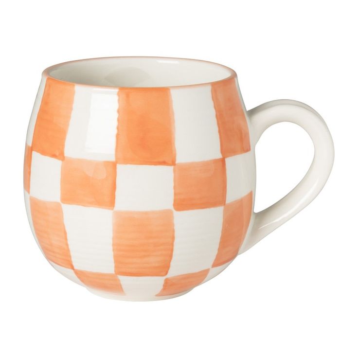 an orange and white checkered coffee cup