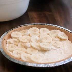 a bowl filled with banana slices on top of a wooden table