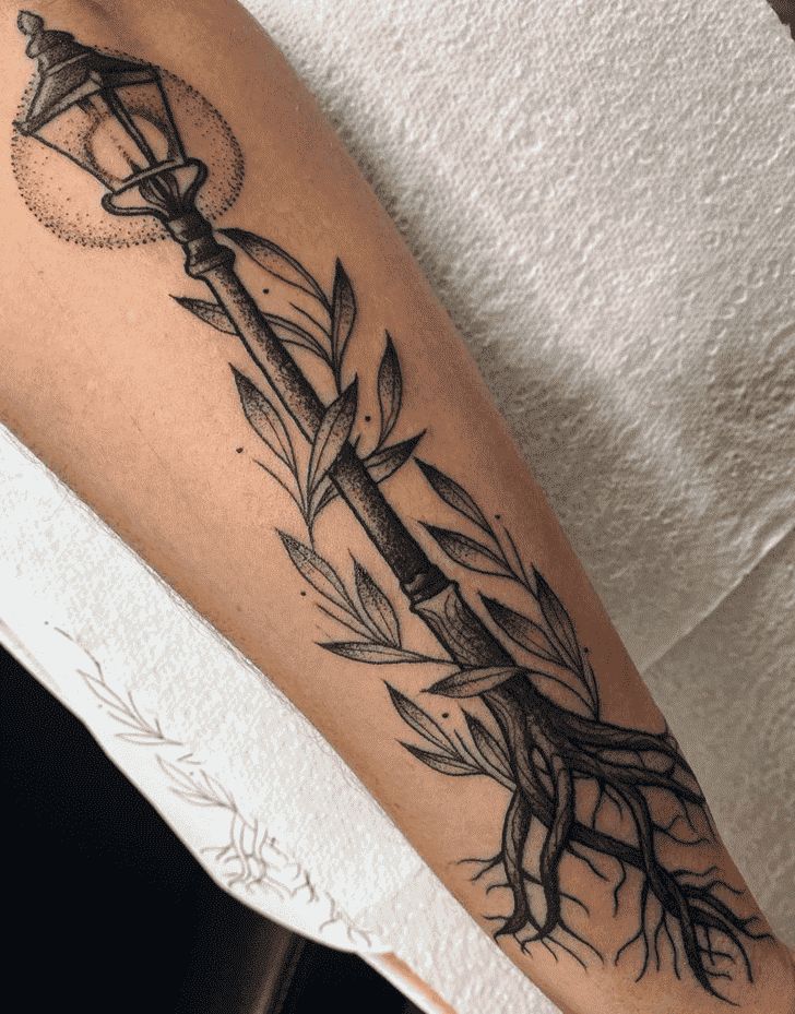 a black and white photo of a person's arm with an arrow tattoo on it