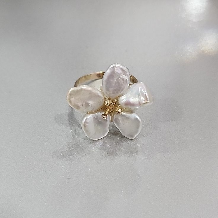 This Is Made Out Of 14k Gold. There Is A Stamp Of 14k Inside The Band. The Pearls Are Freshwater Keshi Pearls. The Size Of The Ring Is A 7. Flower Shaped Pearl Ring For Wedding, Formal White Gold Flower Ring, Fine Jewelry White Gold Flower Pendant, Elegant White Sterling Silver Flower Ring, White 14k Gold Flower Shaped Ring, White 14k Gold Flower Ring, White Gold 14k Flower Ring, Dainty White Flower Ring For Wedding, Delicate White Flower Ring For Wedding