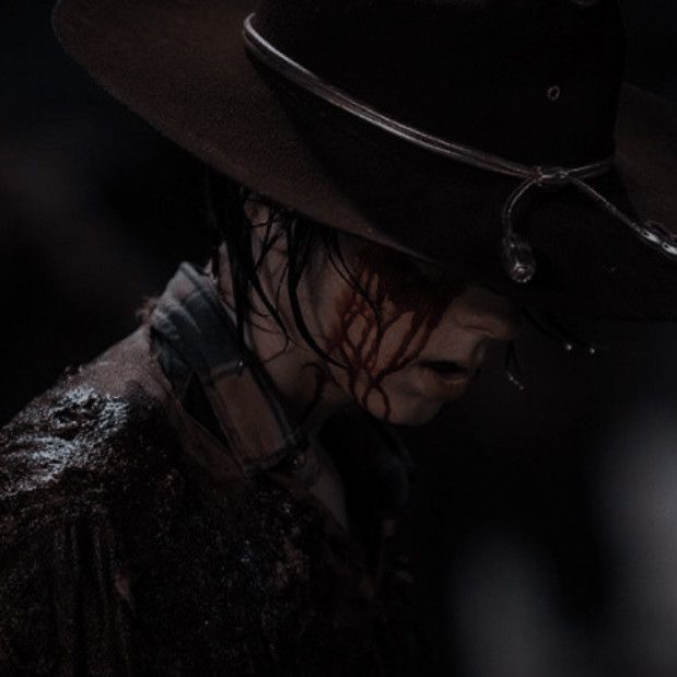 a man in a hat with blood on his face