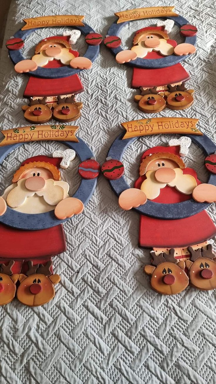 christmas decorations made to look like santa clauses on a bed with white sheeting