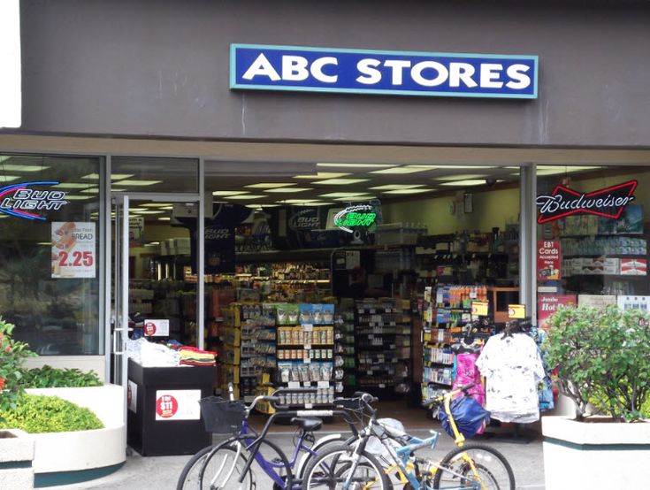 two bicycles are parked in front of a store