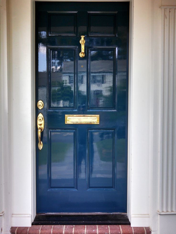 a blue front door with gold handles on it