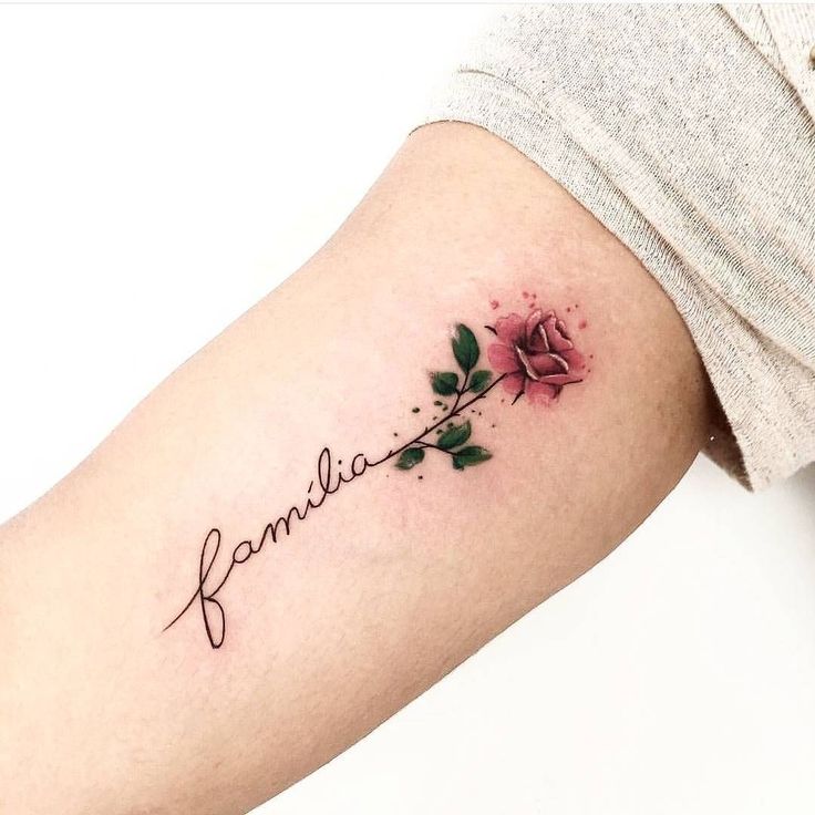 a woman's arm with a rose and the word familla tattooed on it