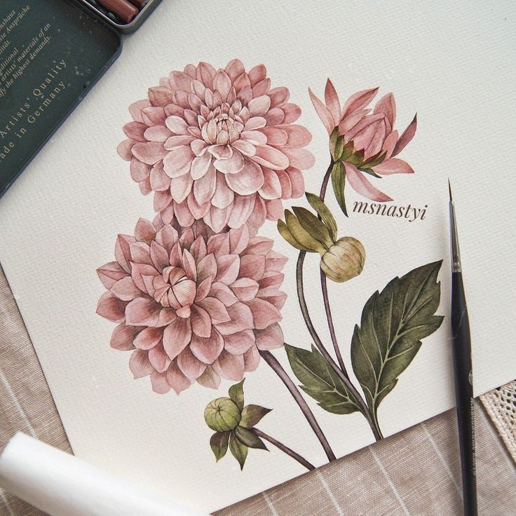 a card with pink flowers on it next to a pen and inking utensil