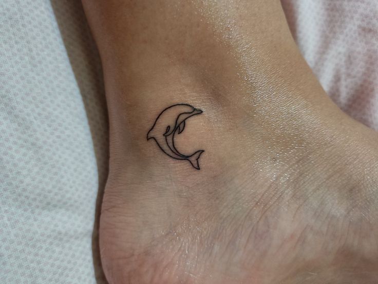 a small dolphin tattoo on the ankle