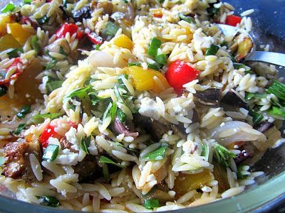 a bowl filled with rice and vegetables on top of a table