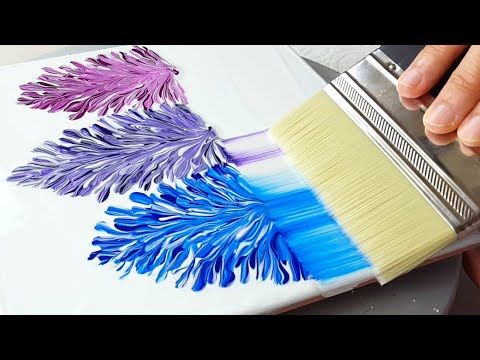 someone using a brush to paint flowers on a piece of paper