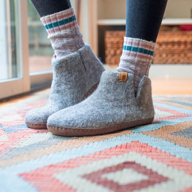 100% all-natural wool from New Zealand Genuine buffalo leather from Nepal Intended for indoor use Handmade by artisans in Nepal Baabushka's superbly cozy felt booties are made with sheep’s wool, water, and organic soap, all handmade by artisans in Nepal using traditional crafting techniques. The result is soft yet durable footwear that provides incredible warmth and comfort. The felted wool is gentle on your feet and naturally insulates yet allows your skin to breathe, which means you can enjoy Felt Booties, Sandals Outfit, Home Slippers, Slippers Cozy, Organic Soap, Green Life, Buffalo Leather, House Shoes, Outdoor Style