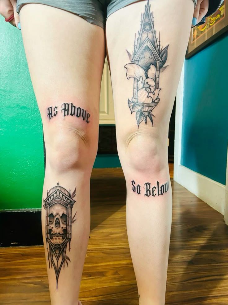 two people with tattoos on their legs standing next to each other