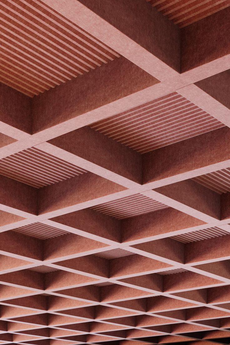 the ceiling is made out of wood and has many square holes in it, as well as lines