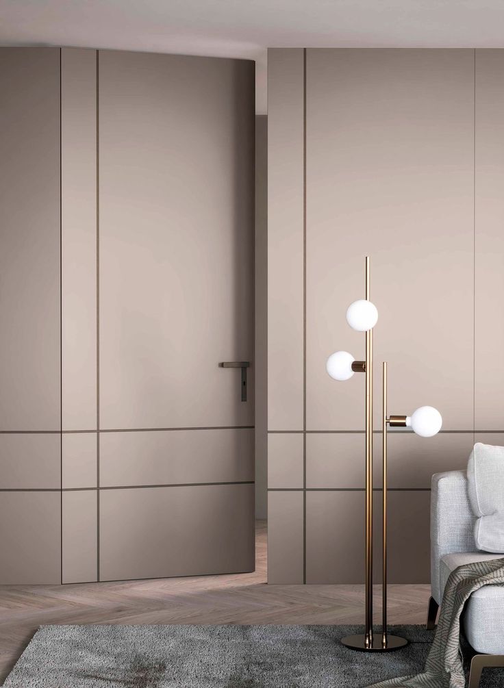 a modern living room with beige walls and floor to ceiling closet doors in the corner