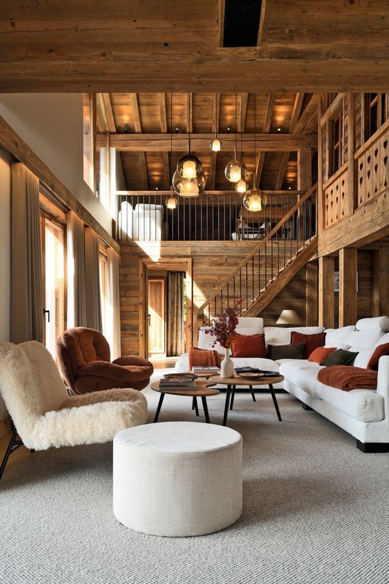 a living room filled with lots of furniture and wooden walls on top of each other