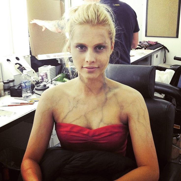 a woman sitting in an office chair with her hands on her hips and looking at the camera