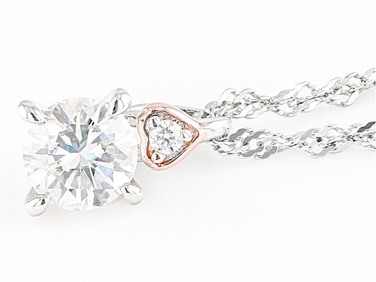 Moissanite Fire(R) .83ctw diamond equivalent weight round, Platineve(R) and 14k rose gold over sterling silver pendant with 18 inch Singapore chain. Measures approximately 7/16" L x 1/4" W. Chain has a spring ring clasp and a 2 inch extender. Actual moissanite weight is .70ctw. Comes with certificate of authenticity. Dazzling Rose Gold Jewelry With Diamond Accents, Anniversary Rose Gold Cubic Zirconia Solitaire Necklace, Rose Gold Jewelry With Round Cut Single Diamonds, Rose Gold Moissanite Solitaire Necklace For Anniversary, Rose Gold Diamond Necklace With Moissanite And Diamond Accents, Anniversary Rose Gold Solitaire Moissanite Necklace, Rose Gold Solitaire Necklace With Diamond Cut Cubic Zirconia, Rose Gold Solitaire Pendant Necklace With Diamond Accents, Rose Gold Solitaire Necklace With Diamond Pendant