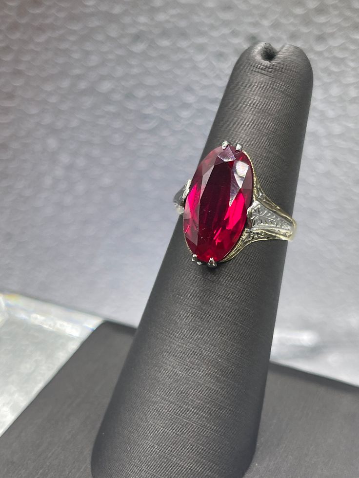 A beautiful ladies antique 14 karat solid yellow and white gold ring with a large oval shaped Ruby stone set in the center.  The gorgeous hand etched floral designs combined with white gold engraved accents make this unique ring truly spectacular.  Weight:  4.3 grams Dimensions:  16.5mm x 10mm Size:  6 Our Price $695.00 Regularly Priced At $1100.00 Please See Our Video Remember - If you're purchasing for yourself or a gift for a loved one, buy with confidence.  We Guarantee Everything We Sell! Formal Oval Engraved Filigree Ring, Classic Oval Ruby Ring, Victorian Oval Engraved Ring For Anniversary, White Gold Ruby Ring With Accent Stones, Oval Shaped, Classic Oval Engraved Ruby Ring, Classic Oval Ruby Ring With Diamond Cut, Luxury Oval Engraved Ring, Heirloom Engraved Oval Ring For Formal Occasions, Oval Diamond Cut Signet Ring For Formal Occasions