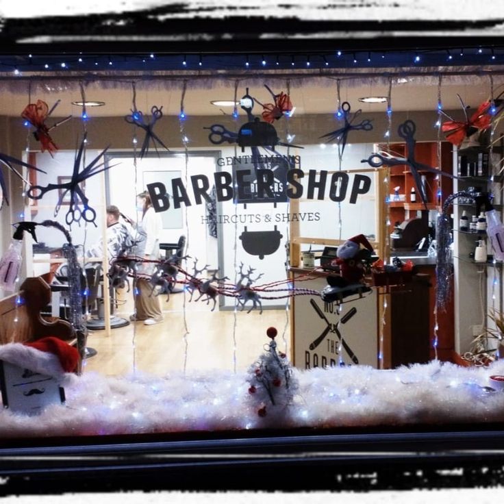 a barber shop window display with scissors and other items in the store's windows