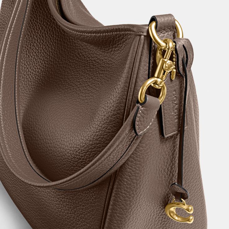 Deliberately slouchy with a sophisticated ease our Cary is a study in intentional laidback style. Crafted of buttery soft pebble leather with a silky sheen this surprisingly spacious bag has plenty of pockets to keep you organized. (Because even your most easygoing self should feel put-together.) | Coach Cary Shoulder Bag - Women's Purses - Brass/dark Stone Coach Cary Shoulder Bag, Elegant Luxury Coach Shoulder Bag, Classy Handbags For Women, Tote Bag Coach, Fall Bags 2024, Luxury Everyday Coach Shoulder Bag, Brown Coach Bag, Shoulder Bags For Women, Coach Bags Handbags