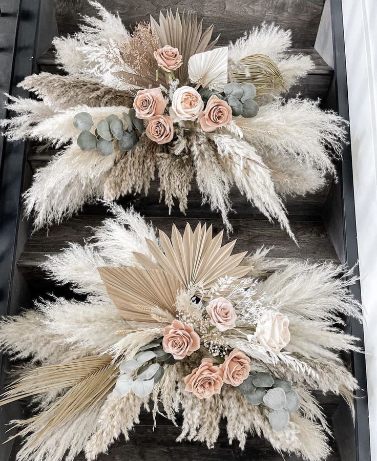 two fake flowers and feathers on top of each other