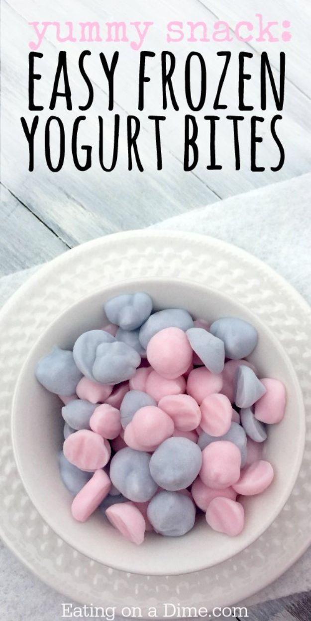 a white bowl filled with pink and blue heart shaped marshmallows on top of a table