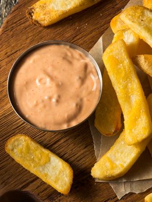 french fries with dipping sauce on the side