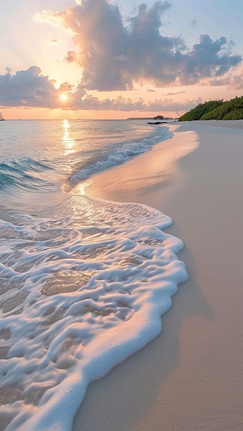 the sun is setting over an ocean beach