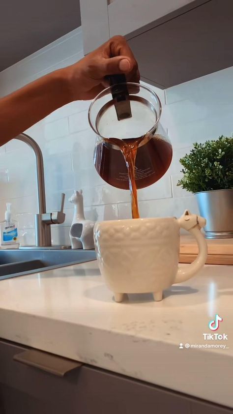 a person pours coffee into a cup