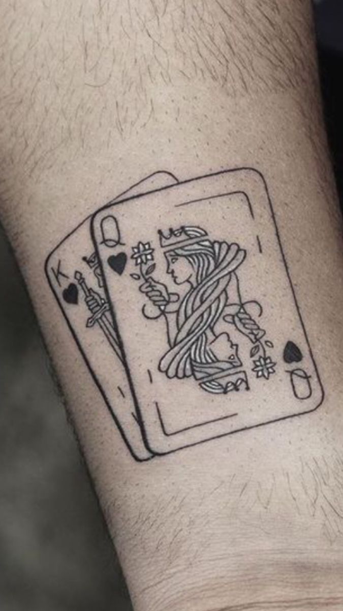 a man's arm with a tattoo on it that has a playing card in the middle