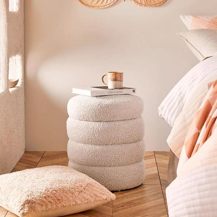 a stack of towels sitting on top of a wooden floor