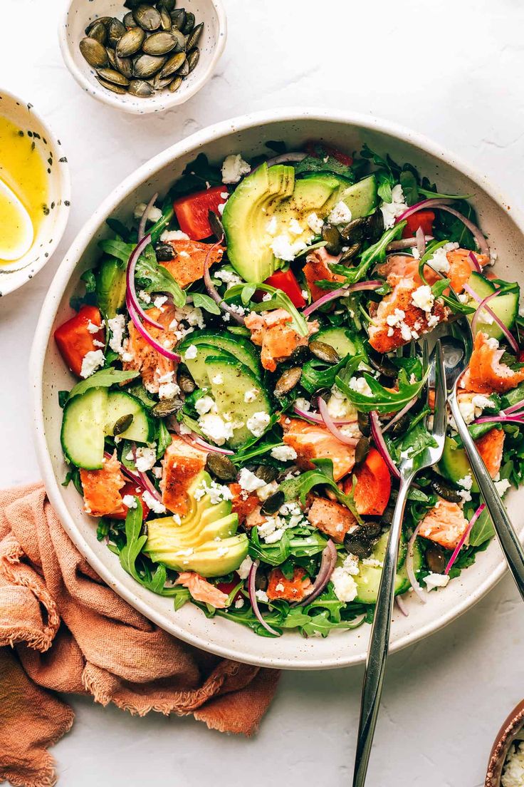 a salad with cucumbers, tomatoes, onions and feta cheese in a bowl