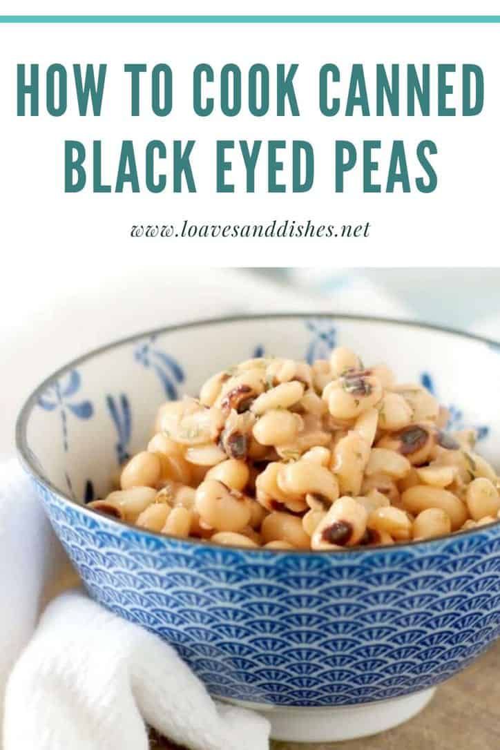 a blue and white bowl filled with black eyed peas on top of a wooden table