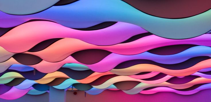 an abstract painting with wavy lines and colors on the wall, as if it were made out of paper