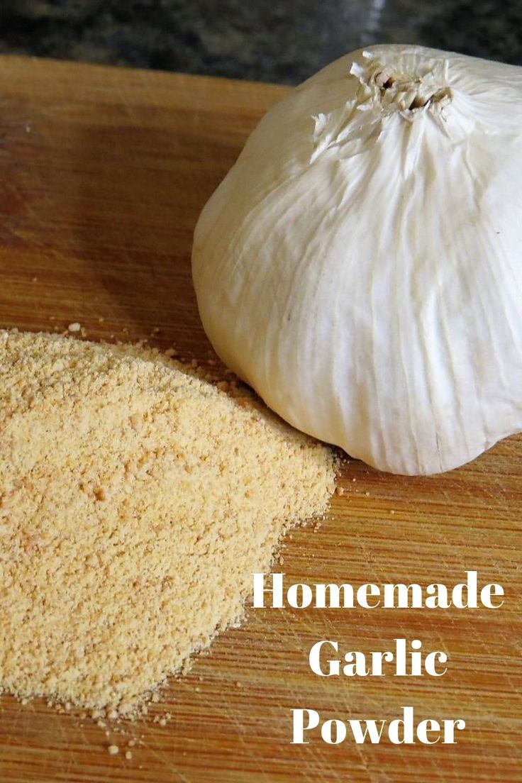 garlic powder next to an uncooked garlic on a cutting board with the words homemade garlic powder