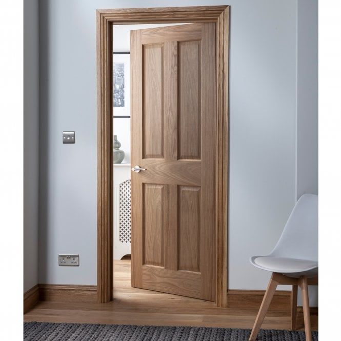 a white chair sitting in front of a wooden door