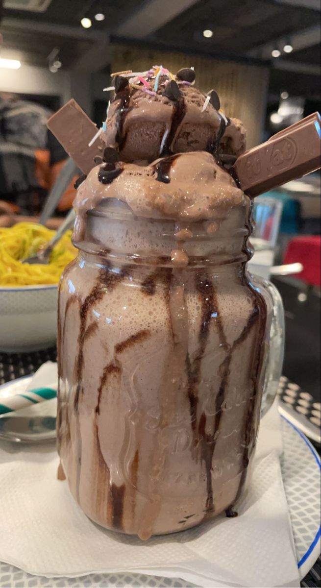 a chocolate dessert in a glass jar on a table