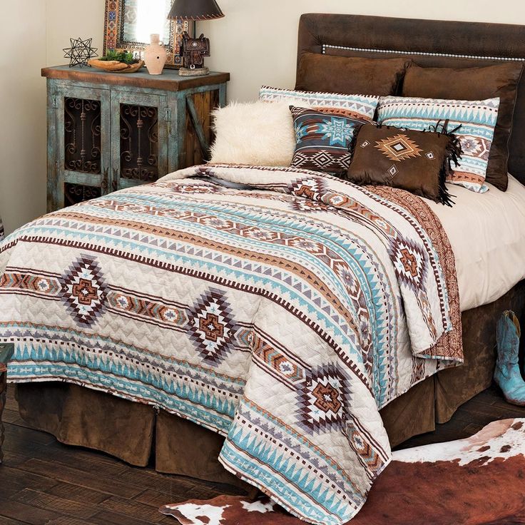 a bed in a room with a cowhide rug on the floor and a brown leather headboard